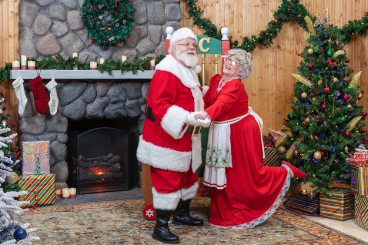 Santa and Mrs. Claus dancing beside the fireplace